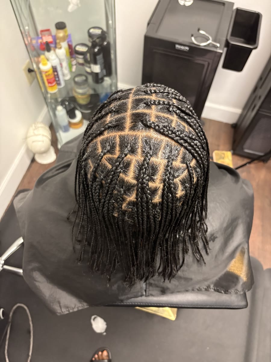 Knotless braids seen from above — perfectly clean parting